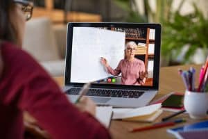 Teacher on screen with whiteboard